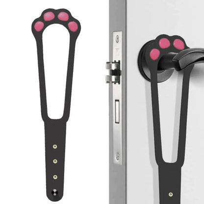 An adjustable cat door latch with a design resembling a cat's paw, shown in two color variations (black with pink paw prints and white with pink paw prints). The product is displayed in use on a door with a dog looking through the latch and a cat waiting outside.