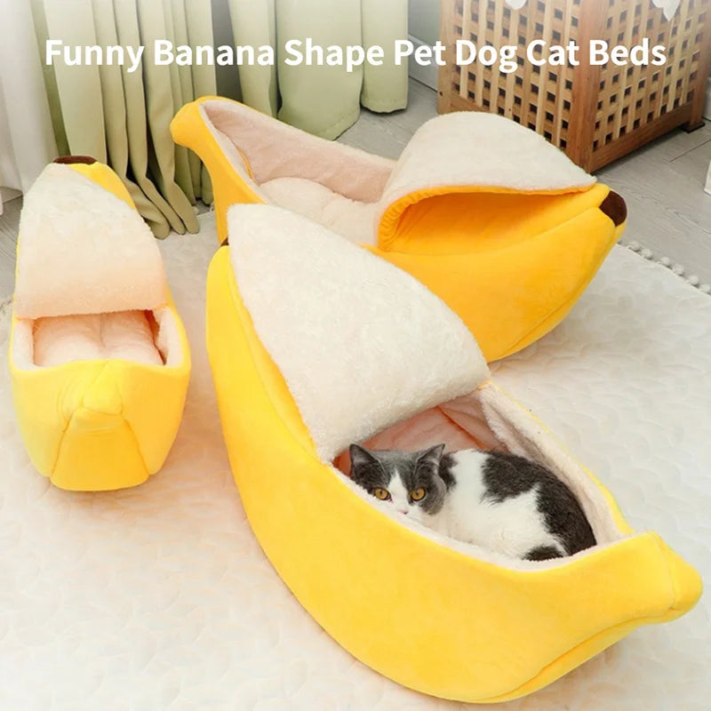 A collection of banana-shaped pet beds in yellow with a plush design, one of which is occupied by a small cat.