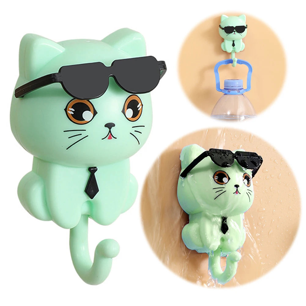 A set of images showing a cartoon cat-shaped keys hook in various states of use, including a visual of the hook attached to a wall.