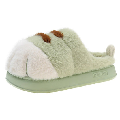 A plush green home slipper with a white and brown cat paw design, featuring a soft, fluffy interior and a flat sole.