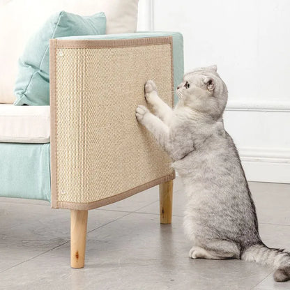 A gray cat interacting with a beige ClawGuard couch protector, which is placed on a couch.