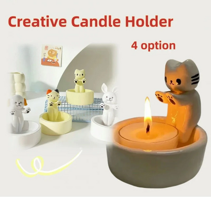 A set of four animal-themed candle holders, with one holding a candle lit, set against a white background. The holders are in the shapes of a cat, dog, and two rabbits, each with a stylized, cartoon-like appearance.