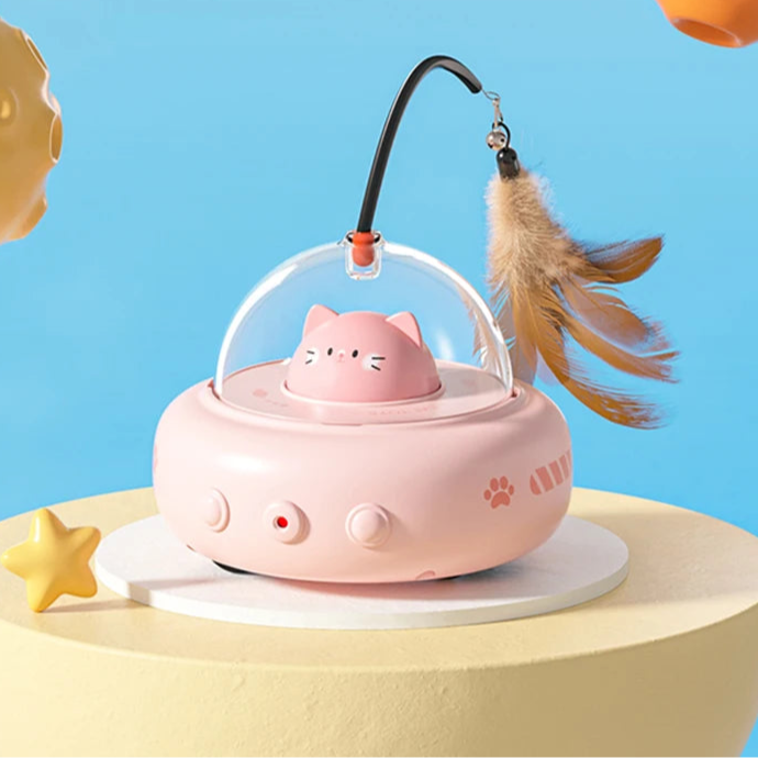 Pink cat-shaped toy with a transparent dome and feather on a blue background