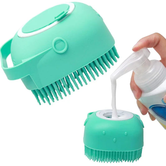 A green shower brush designed for cats, with soft silicone bristles, being shown in a hand and also placed under a shower of water and shampoo to demonstrate its use.