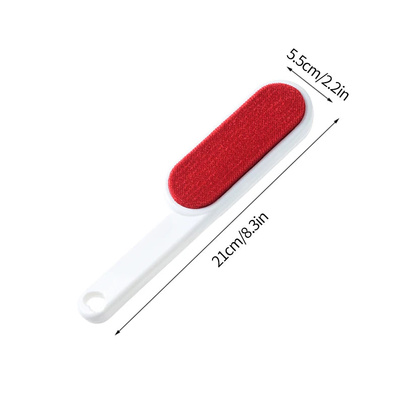 A lint roller with a white handle and a grey roller head, shown being used to remove lint and fur from a person's sweater. There are additional rollers with different colored attachments displayed beside it.