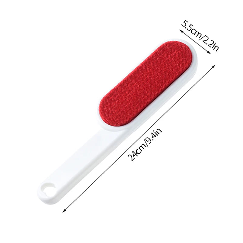A lint roller with a white handle and a grey roller head, shown being used to remove lint and fur from a person's sweater. There are additional rollers with different colored attachments displayed beside it.