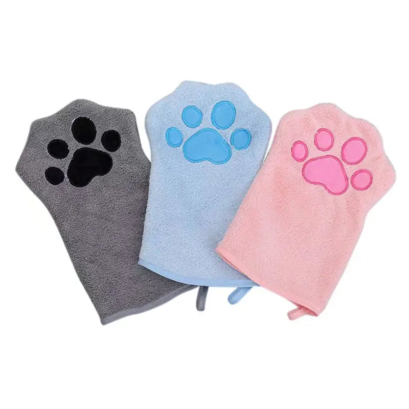 Three microfiber pet grooming gloves in gray, blue, and pink, each featuring a paw print design on one side.