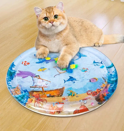 A cat lying on a round water-filled bed with a colorful sea creature print.