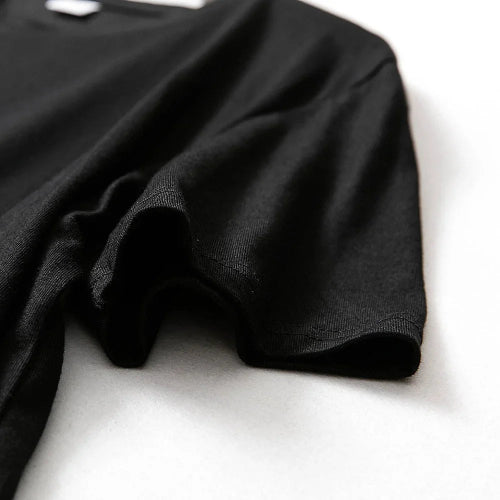 Black t-shirt on a white surface