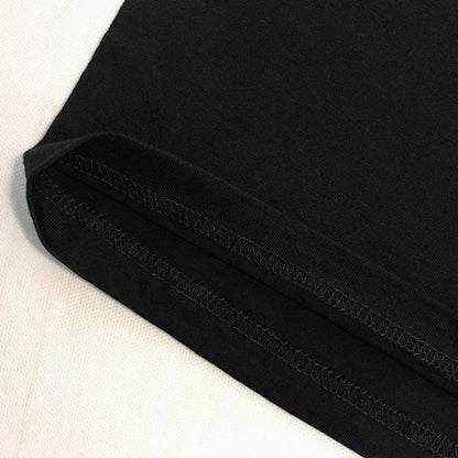Close-up of black fabric with visible stitching on a light background