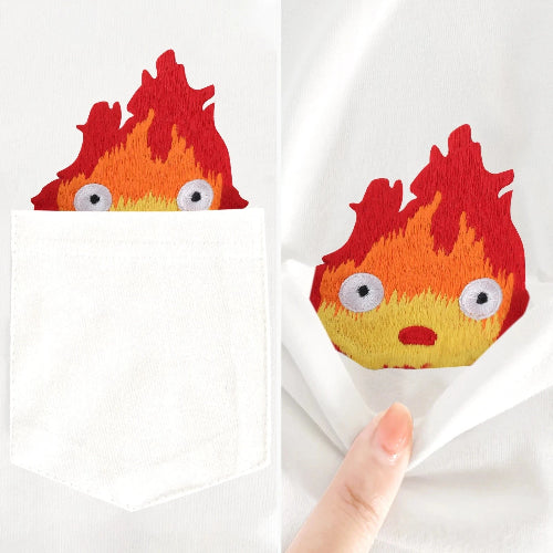 Flame-shaped plush toy with a hand holding it against a white background