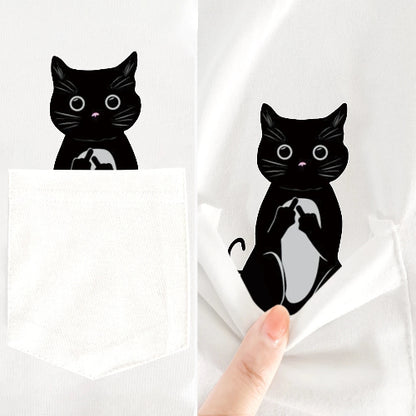 Black cat illustration on a white fabric with a hand holding it.