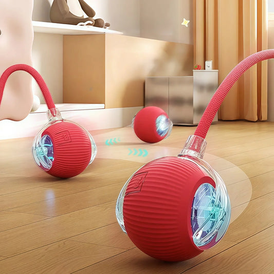 A red and clear rolling ball toy with a faux tail, seen in an indoor setting, potentially interacting with a cat.
