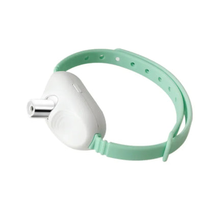 A green and white cat toy collar with a laser-like attachment on top.
