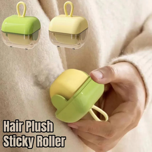 A hand holding a green and yellow washable pet hair and lint remover with sticky roller technology.