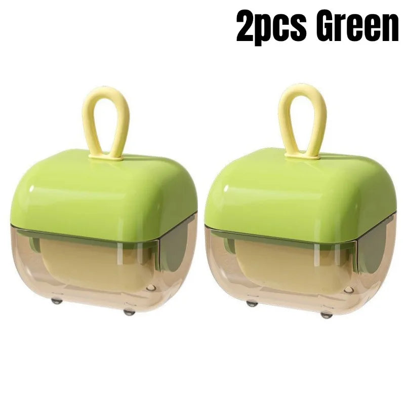 A pair of green washable pet hair and lint removers with a transparent bottom and a yellow loop for easy handling.