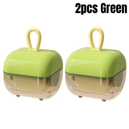 A pair of green washable pet hair and lint removers with a transparent bottom and a yellow loop for easy handling.